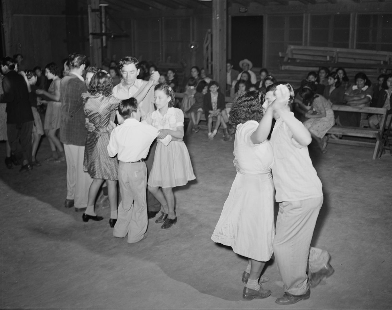 historic photo of couples dancing in a traditional texas dance hall